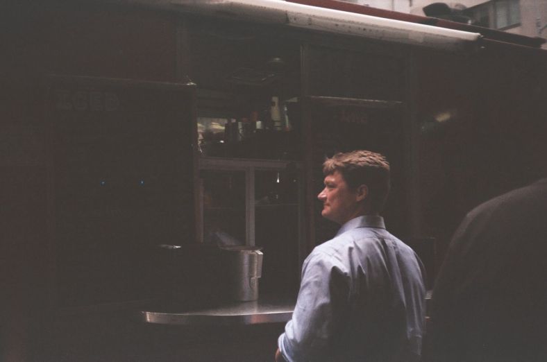 "Man at Food Cart". credit: M. Pitter/In Parentheses